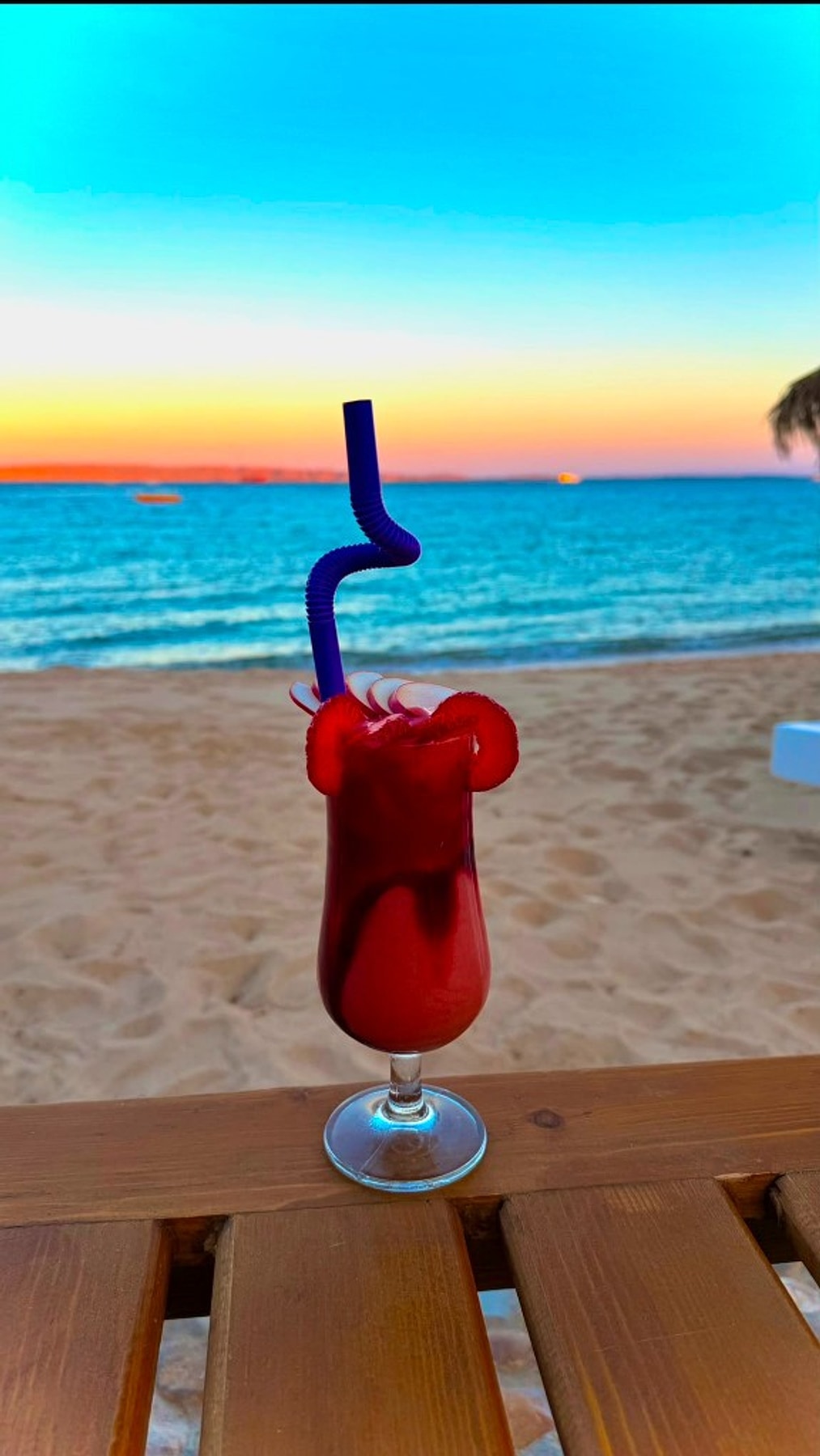 A cocktail by the beach at sunset